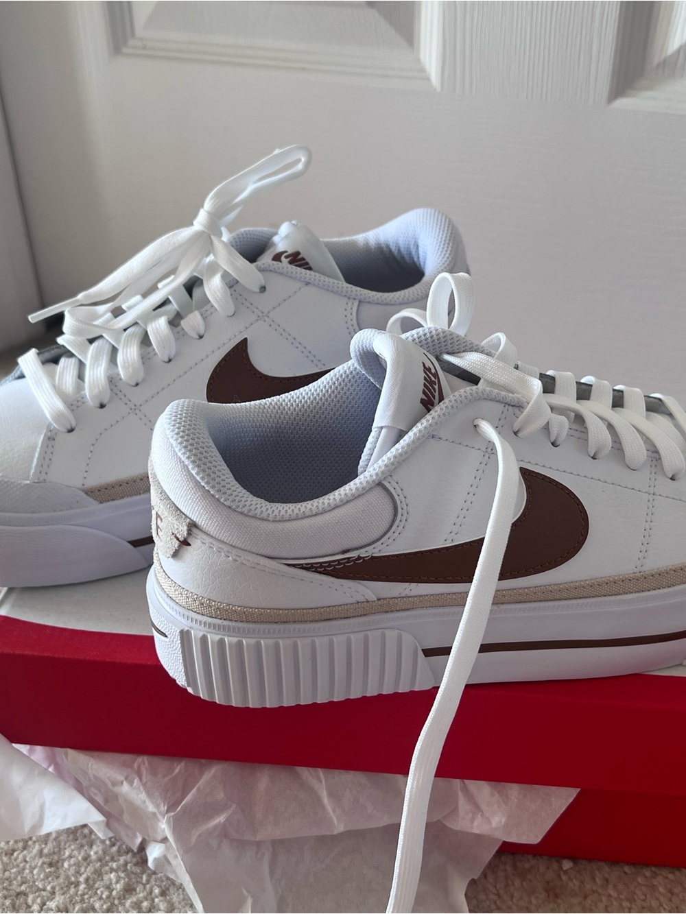 Nike Women’s White Sneakers with Brown Swoosh